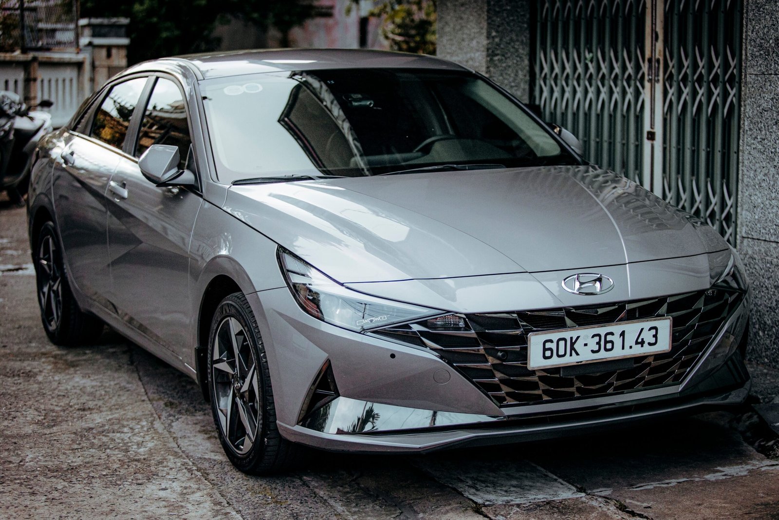 Close-up of a modern silver sedan parked on an urban street, showcasing sleek design.